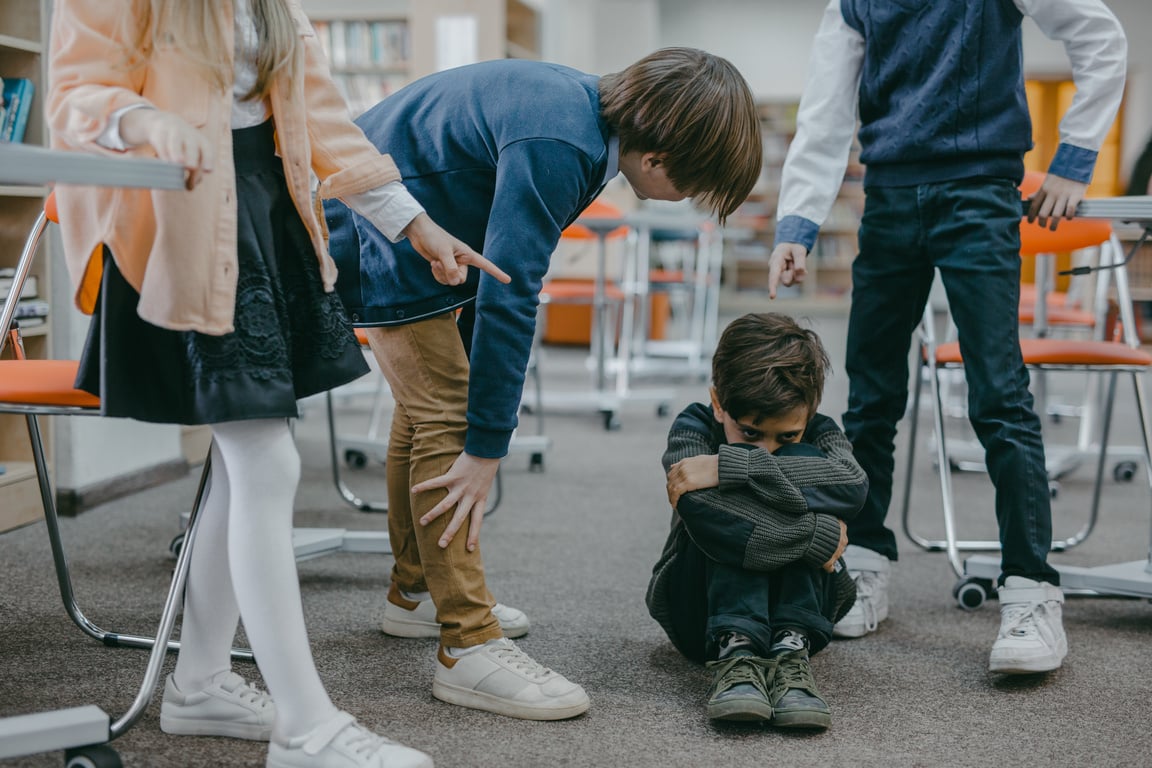 A Boy in Gray Sweater Sitting on the Floor